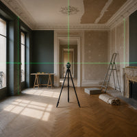 Niveau laser Kovarek K16 Pro sur trépied dans une pièce en rénovation, lignes vertes
